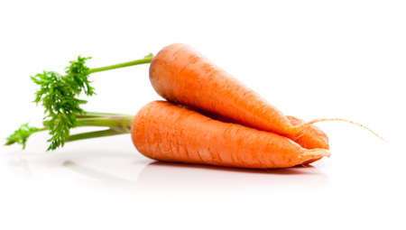 Heap of carrots isolated on whiteの写真素材