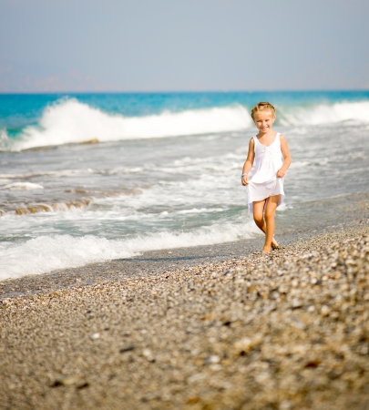 pretty little girl on tropical beach vacationの写真素材