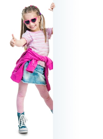 funny little fashion girl show thumb behind a white boardの写真素材
