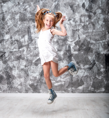 Cute little girl in dress jump  Studio shot の写真素材