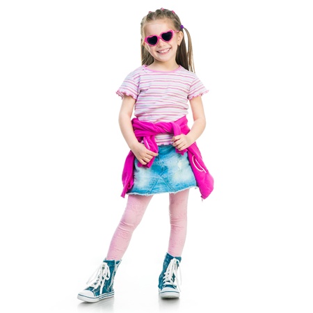 beautiful little fashion girl in gym shoes and skirt on white backgroundの写真素材