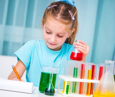 cheerful little girl with flasks for chemistryの写真素材