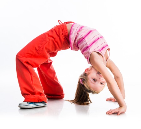 happy cute little girl goes in for sports on a whiteの写真素材