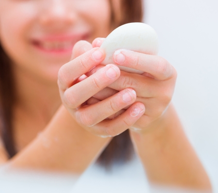 little girl washing her hands with soap  close-upの写真素材