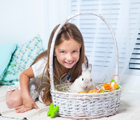 Easter photo  happy little girl and rabbitの写真素材