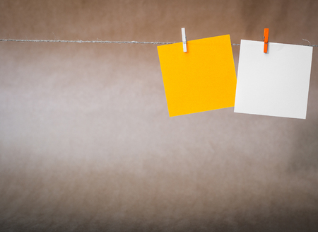 two cards hanging on the rope  kraft paper backgroundの写真素材