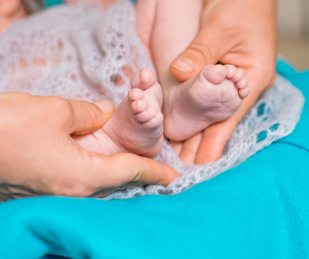 newborn baby feet on female handsの写真素材