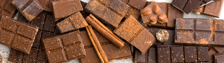 variety of chocolate on a wooden background with space for text