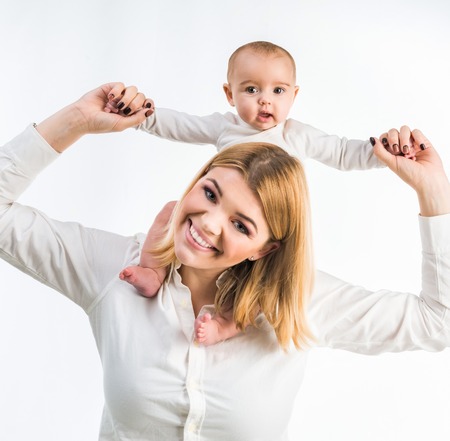 young mother with her six-month daughter. Isolated on white backgroundの写真素材