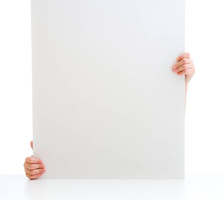 hands of a little girl holding a poster with space for textの写真素材