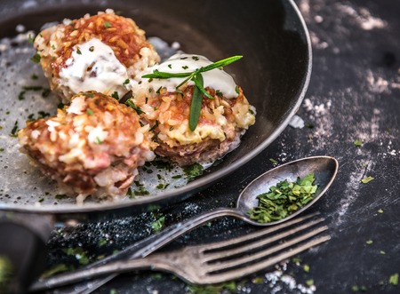 meatballs cooked at home in the old frying pan on a dark backgroundの写真素材