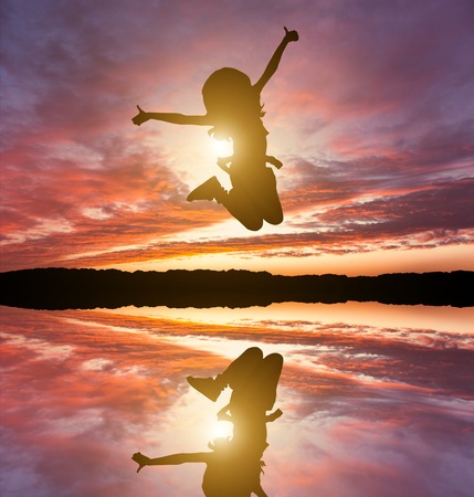 Cute little girl jump. Studio shot. White backgroundの写真素材