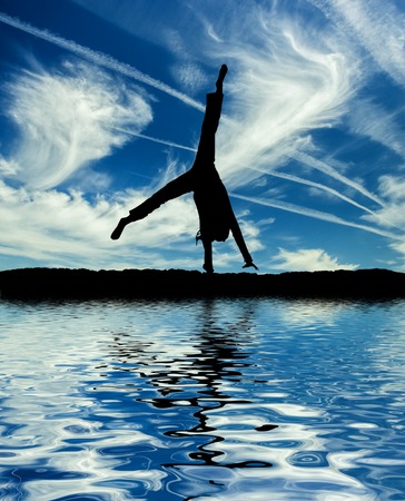 Little ballet dancer make cartwheel isolated on a white backgroundの写真素材