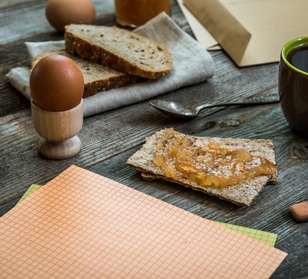 breakfast business person. coffee, sheets of notes and stationery on wooden tableの写真素材