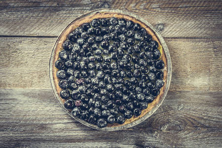 Tart with blueberries on a wooden background. top viewの写真素材