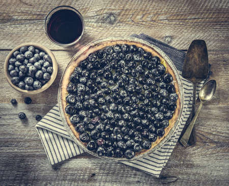 Tart with blueberries and juice on a wooden background. top viewの写真素材