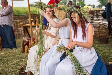 Warsaw, Poland -JUNE 20: Young girls make wreaths of flowers on festival of midsommar near the old town in Warsaw, Poland June 20, 2015のeditorial素材