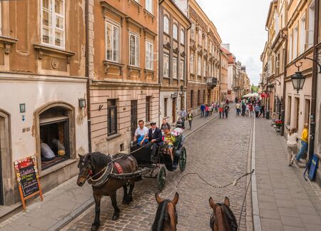 WARSAW, POLAND - JUNE 20, 2015:  Street in the old town near the market square. A popular place among tourists in June 20, 2015 in Warsaw, Poland.のeditorial素材