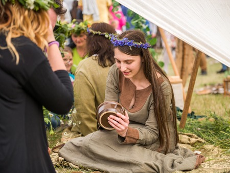 Warsaw, Poland -JUNE 20: Girl shows pottery handmade on festival of midsommar near the old town in Warsaw, Poland June 20, 2015のeditorial素材