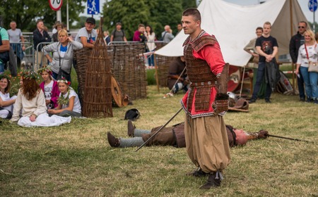 Warsaw, Poland -JUNE 20: Polish man show mastery of the sword on a festival of midsommar near the...