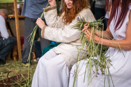 Warsaw, Poland -JUNE 20: Young girls make wreaths of flowers on festival of midsommar near the old town in Warsaw, Poland June 20, 2015のeditorial素材