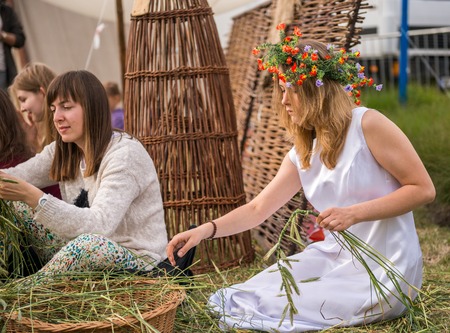 Warsaw, Poland -JUNE 20: Young girls make wreaths of flowers on festival of midsommar near the old town in Warsaw, Poland June 20, 2015のeditorial素材