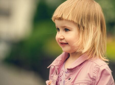 Beautiful 2 year old girl in the street close upの写真素材