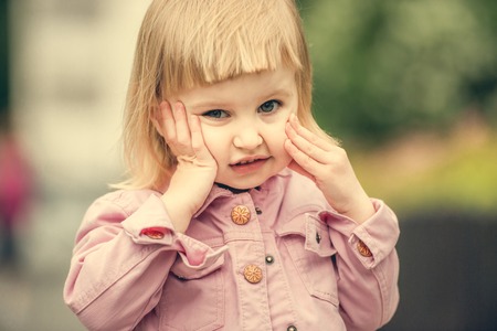 Beautiful 2 year old girl in the street close upの写真素材