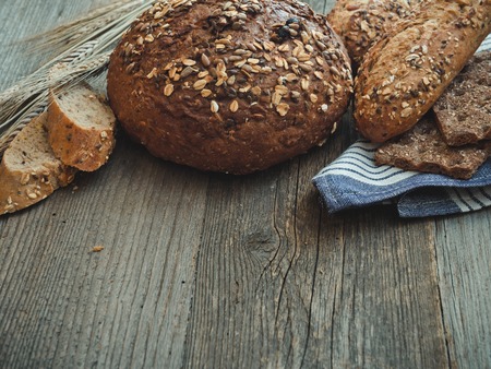 Different types of bread on a wooden backgroundの写真素材