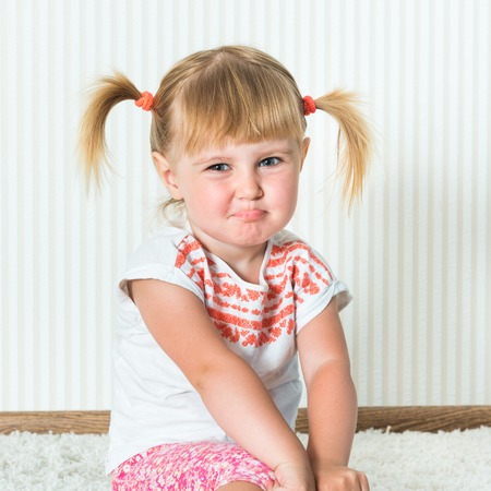 2-year-old funny girl engaged in physical activity at home