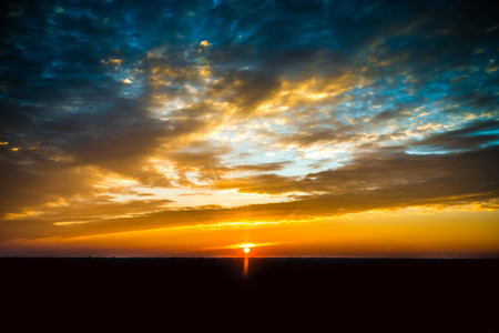 Fiery sunset sky. Beautiful cloudsの写真素材