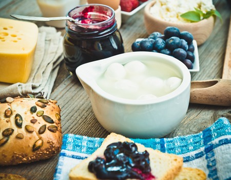 Summer breakfast. fruit and dairy products on a wooden tableの写真素材