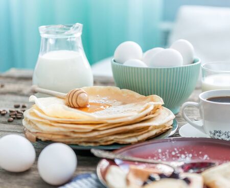russian puncakes and ingredients on wooden backgroundの写真素材