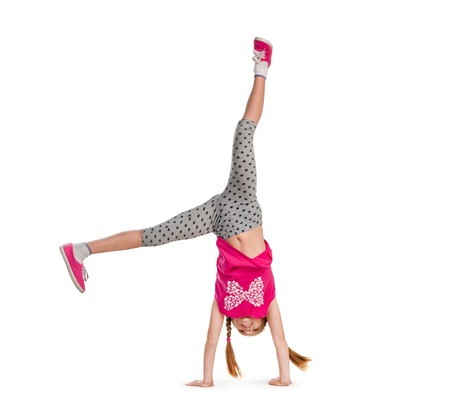 little girl turning handsprings in a studioの写真素材