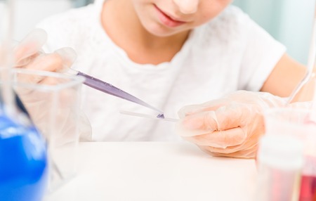 cute little girl with flasks for chemistryの写真素材