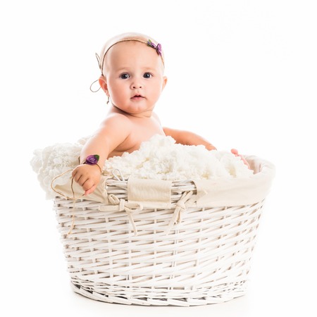 cute little baby in a wicker isolated on white backgroundの写真素材