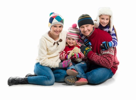 happy family portrait in warm clothes isolated on white backgroundの写真素材