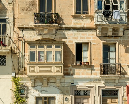 street with traditional balconies in historical center of Valletta in Maltaの写真素材