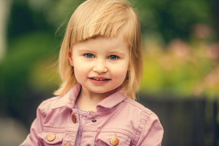 Beautiful 2 year old girl in the street close upの写真素材