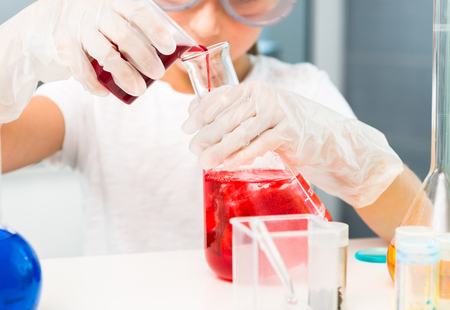 cute little girl with flasks for chemistryの写真素材