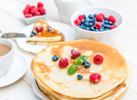 breakfast with pancakes on wooden tableの写真素材