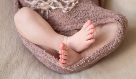 sweet feet of newborn baby close-upの写真素材