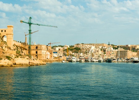 view of Valletta city and port with cranes and boats from the sea, Maltaの写真素材