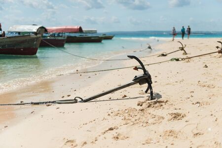 anchores from touristic boats on sandy beach of Zanzibar, Africaの写真素材