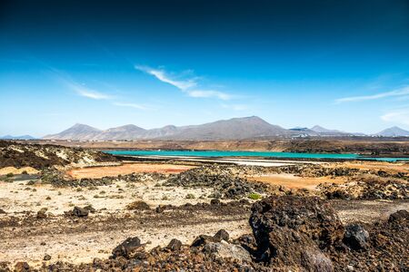 Colorful landscape with volcanic lake, blue sky and mountains on the background, Canary island, Lanzaroteの写真素材