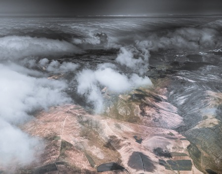 breathtaking aerial view of Lanzarote mountain terrain with clouds from high, Canary Island, Spainの写真素材