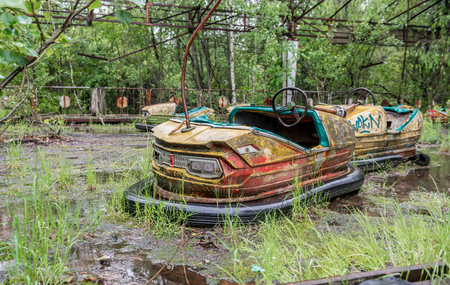 rusty cars in abandoned playground of Pripyat park, Chernobylの写真素材
