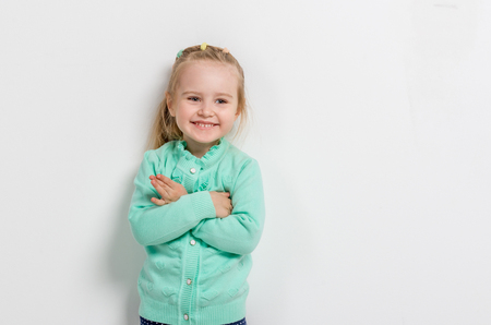cheerful little girl with her arms foldedの写真素材