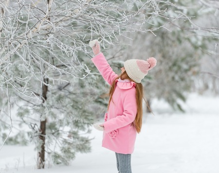 Child touching a tree, sideviewの写真素材