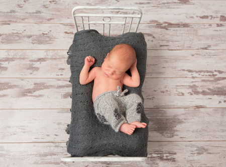 Kid napping on a tiny bed, topviewの写真素材